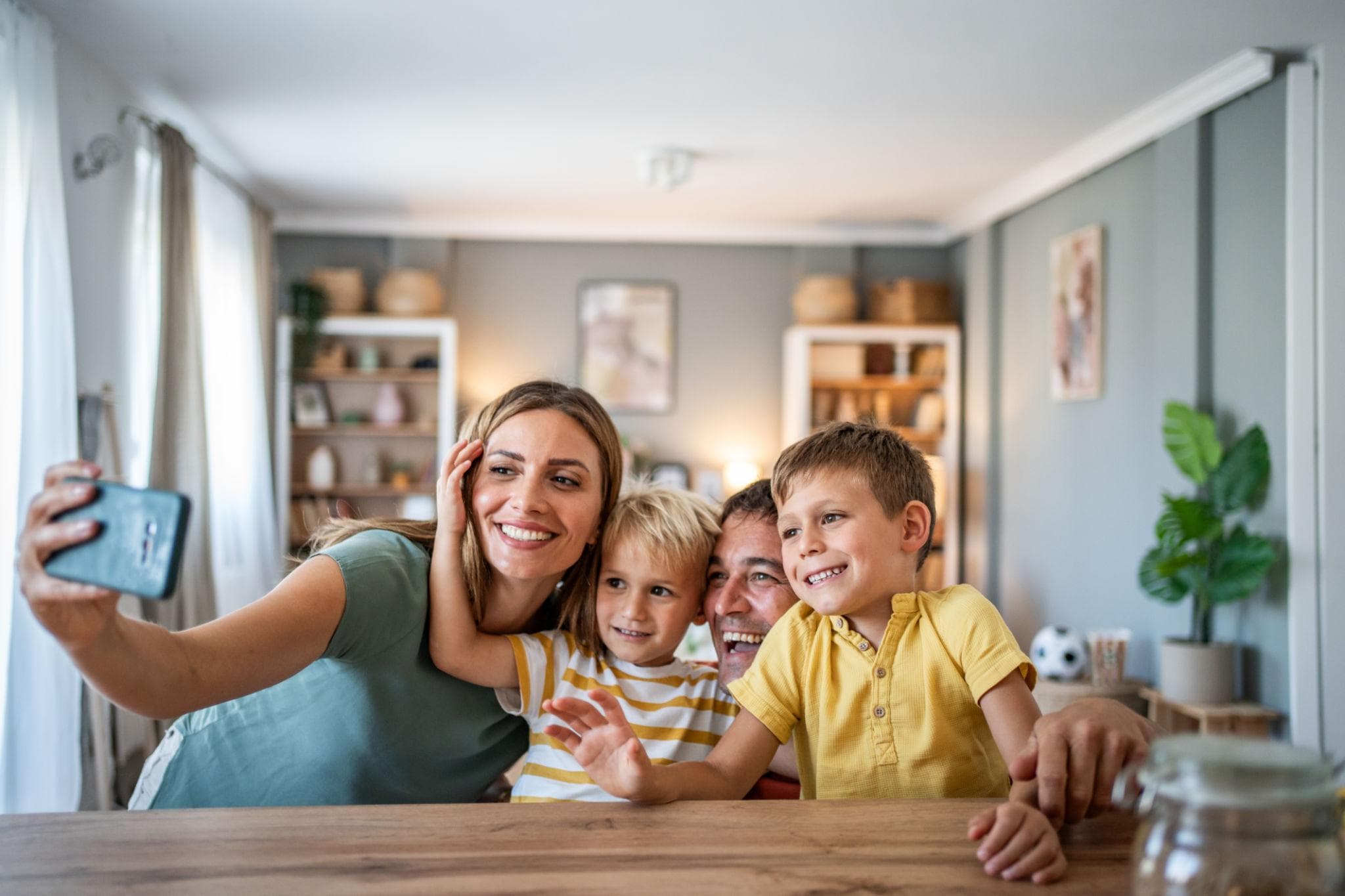 Photo tiles styled above a modern bed